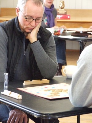 Scrabble player John McKinnon studying his next move.