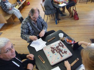Alec Lund keeps an eye on the score while Chris looks a little worried.  Janet, Committee Secretary hopes to pull a good letter from the bag.